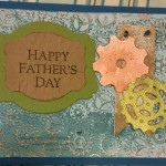 Gear embossing folder with CTMH cricut Artist cartridge. Stampin Up papers and Viva metallic rub.
